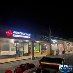 employees power washing a commerical strip mall in Toms River, NJ